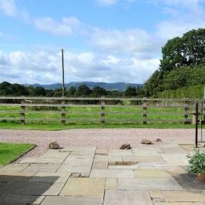 On the patio with view of The Hills