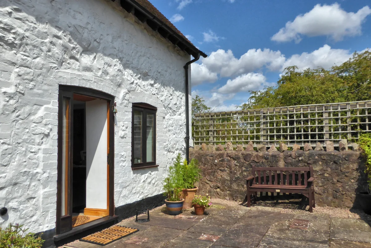 Rhydd Barn - sunny private patio bench and flower pots